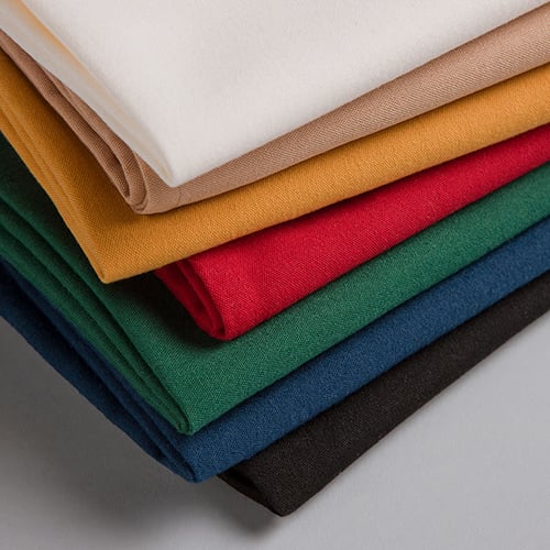 Stack of folded table napkins in assorted colors