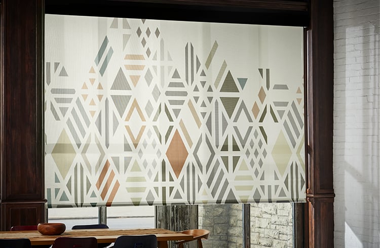 Window with patterned solar shade providing filtered daylight.