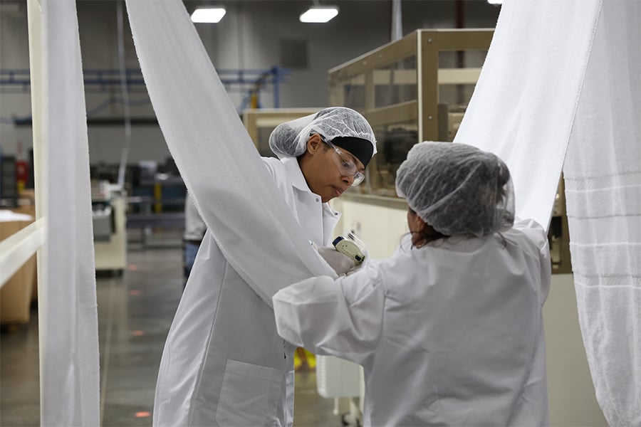 Image of associate observing the textiles being processed in Union, SC. It is a great place to work if you're looking for jobs in Union SC hiring.