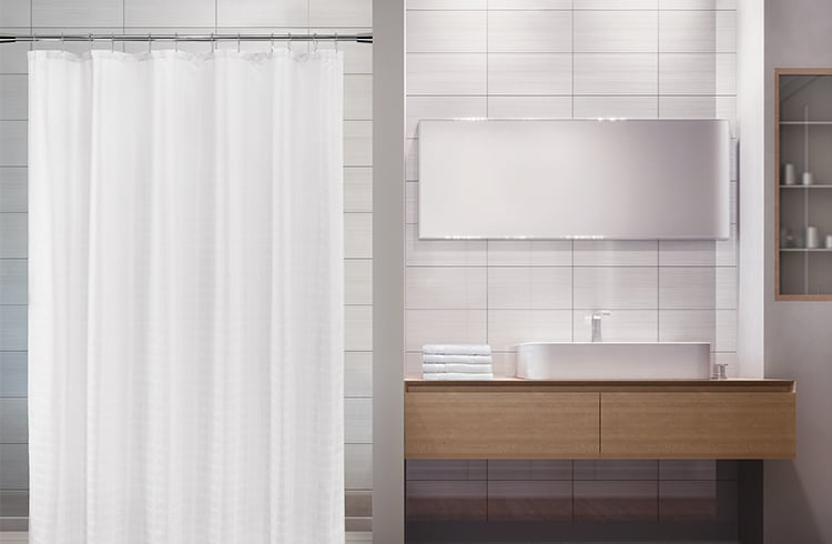 Modern campus bathroom with sink vanity, mirror, and shower curtain.