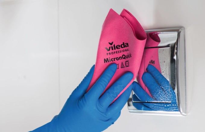 close up view of a microfiber wipe disinfecting a healthcare surface