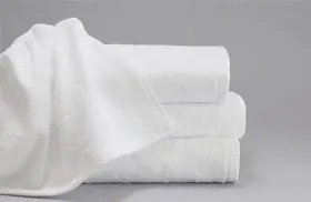 This is a stack of three towels for hotels. The ForeverSoft bath towels have one towel artistically draped over over the others.