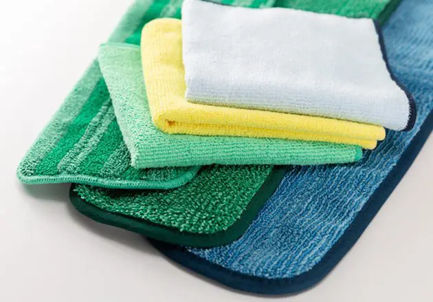 A stack of various size and color microfiber cleaning cloths.