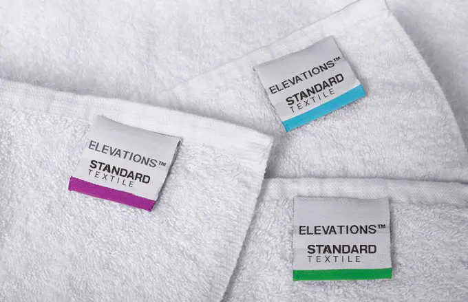 Color-coded labels indicate the weight of a towel.