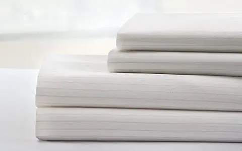 Photo of a stack of DermaTherapy® bedding linens.