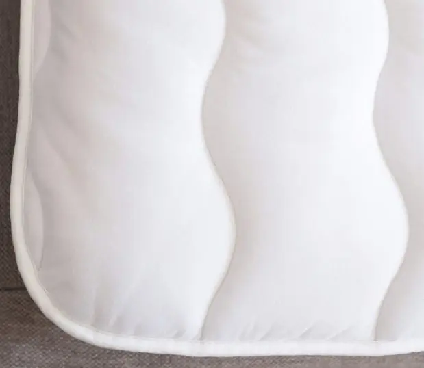 Image is a detail of the plush mattress pad, Comfort Cloud.