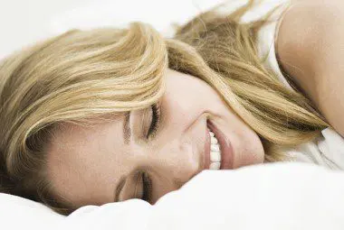 Woman taking a nap on a soft, comfortable cotton blanket