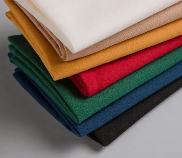 Multi-color stack of Avila polyester napkins.