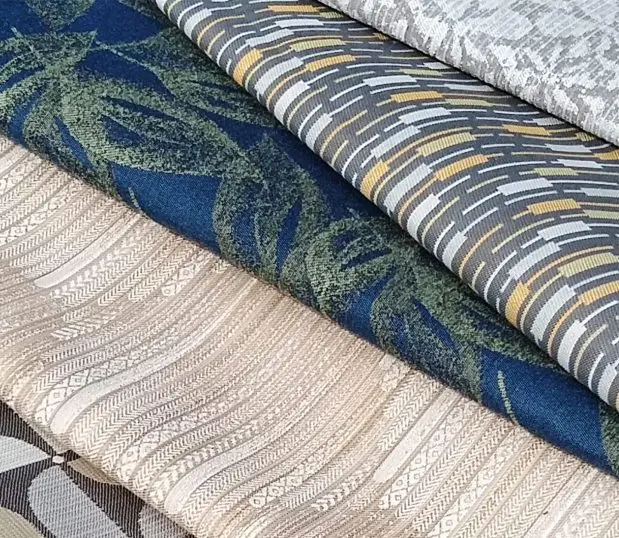 A several of Crypton fabrics in a variety of patterns and color are stacked to reveal texture.