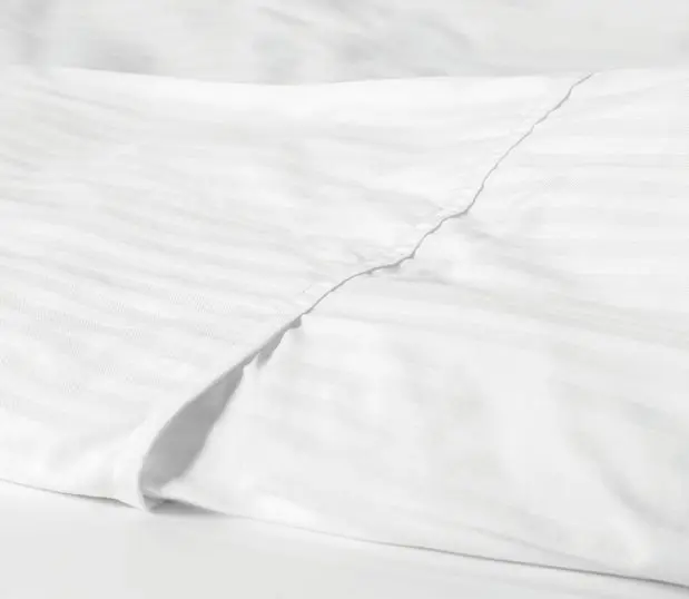This subtly striped duvet cover delivers hotel quality comfort and durability. Shown here: a detail shot of a designer closure ComforTwill duvet.