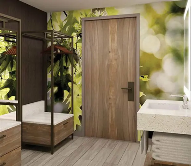 Custom wallcovering of sunlight coming through green leaves shown in an upscale hotel bathroom.