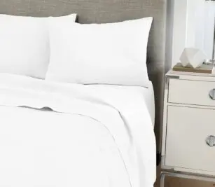 Image shows our luxurious Centium Satin sheets and pillowcases on a hotel bed.