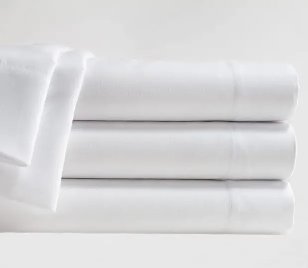 Stack of white Microfiber sheets, These wholesale sheets offer effective performance at an affordable price.