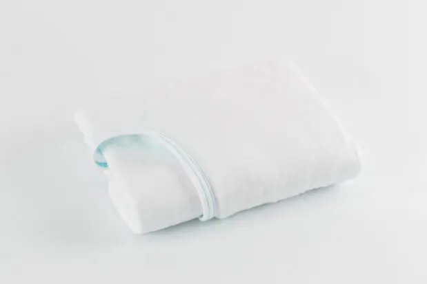 E*Star® Fitted Sheets in White jersey knit sewn with aqua binding. Shown folded.