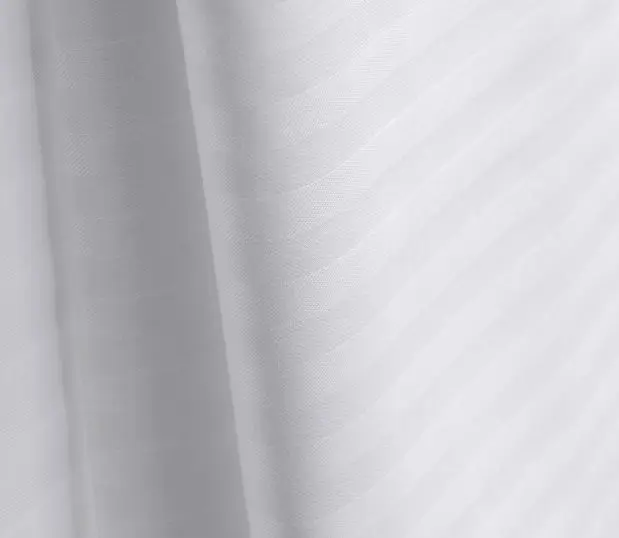 Add a subtle touch of sophistication to your top of bed with this decorative stripe top sheet. Image shows a detail shot of a ComforTwill stripe top cover.
