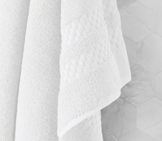 A favorite of a former US President, these luxury bath towels made in America will impress five-star guests and dignitaries alike. Try them today! Image shows a detail shot of the decorative dobby border of the capitol collection bath towel.