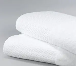 Stack of two white Elevations towels.