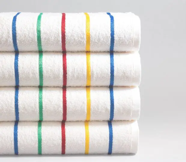 Set of four Festival striped pool towels. The towels have blue, yellow, red and green stripes.