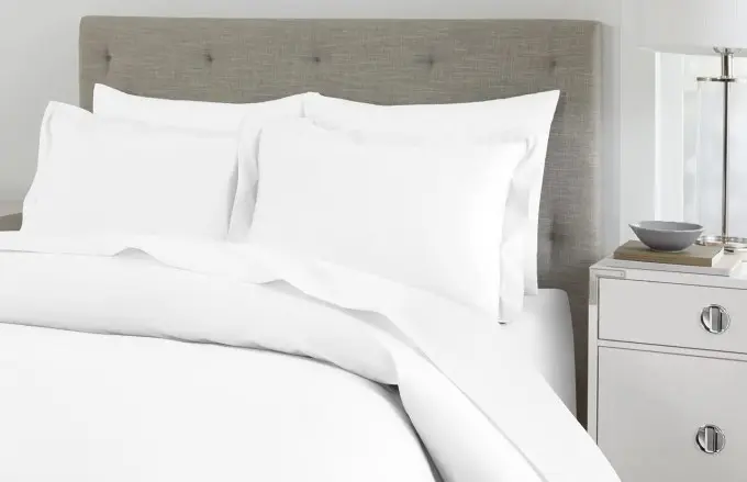 A luxe duvet cover atop a plush hotel guest bed.