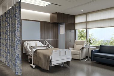 A patient room featuring patterned cubicle curtains.