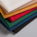 A stack of folded, multicolor Avila cloth napkins.