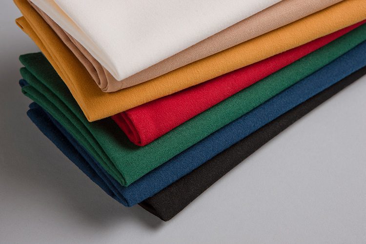 A stack of folded, multicolor Avila cloth napkins.