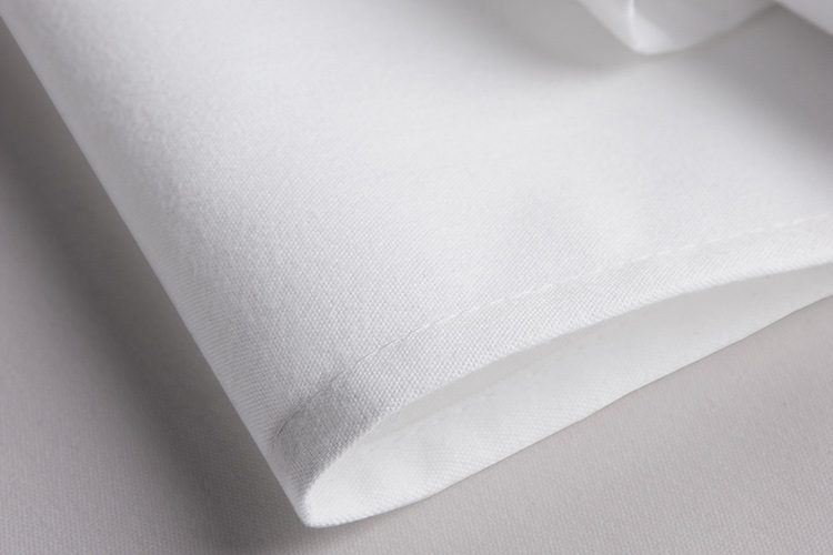 A crisp, folded white Avila napkin