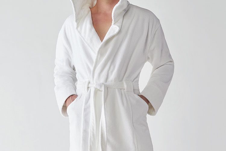 A man wearing a Heidi Weisel Bailey hotel robe.