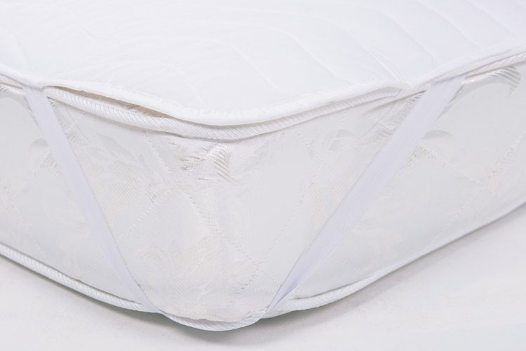 A detail shot of a mattress featuring our Basic Mattress pad.