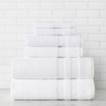 A stack of folded Capitol Towels with a white subway tile background.