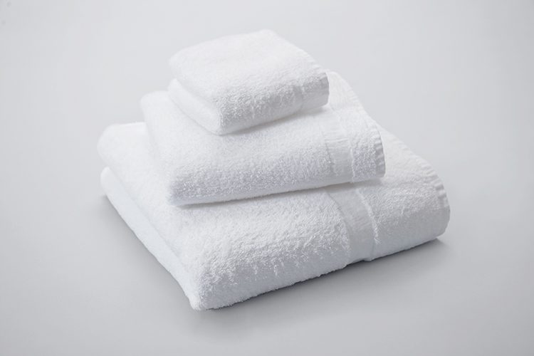 A folded stack of Classic Cam terry, featuring a bath towel, hand towel, and wash cloth.