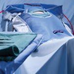 A staged surgical scene featuring ComPel Surgical Drapes and Covers.