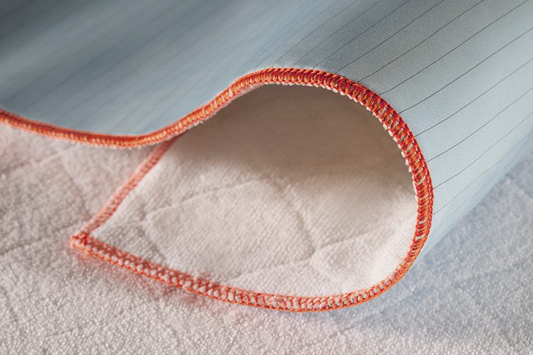 A detail shot of ComPly MVP underpads. The top surface of these incontinence pads is comfortable, quick-drying, and reduces shear and friction, enhancing patient care.