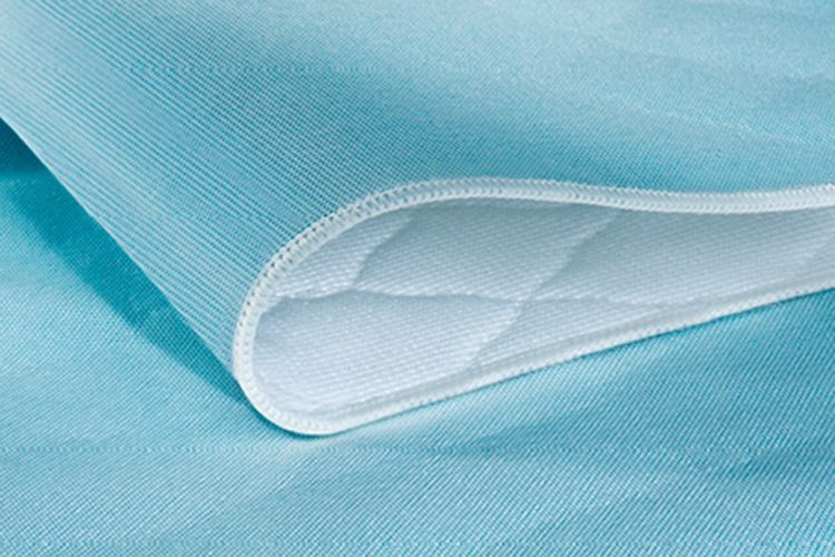 ComPly® reusable underpads save up to 50% over the total cost of disposable systems. These reusable incontinence pads have exceptional strength and durability. ComPly®, the hospital bed pads shown here, have a patented tri-component construction that wicks fluid away from the patient.