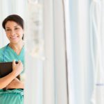 A female doctor standing, partially obscured by cubical curtains.