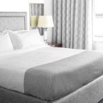 Well made hotel bed with Cumulus top cover in StormCloud.
