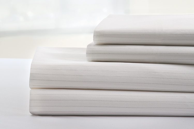 A stack of DermaTherapy® Sheets. DermaTherapy is FDA cleared medical device in the prevention of pressure ulcers and the treatment of existing skin damage.