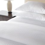 A detail shot of a hotel bed featuring our Designer Closure Duvet Cover.