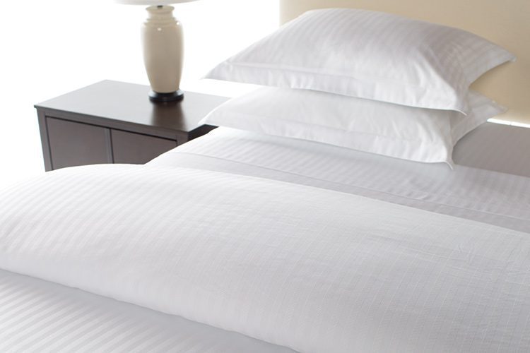A detail shot of a hotel bed featuring our Designer Closure Duvet Cover.