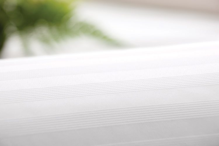 A detail shot of Centium Satin Tuxedo Stripe designer closure duvet cover.