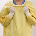 demonstrating easy release feature of isolation gown