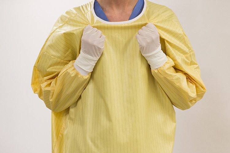 demonstrating easy release feature of isolation gown