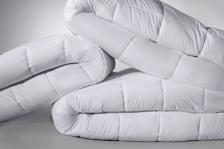 Image of several white Elevations comforters.