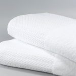 A stack of two folded Rainfall Elevations bath towels.