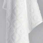 A detail shot of the dobby border of an Elevations bath towel.