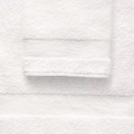 Detail of A stack of white EuroClassique hotel bath towels.