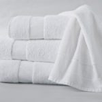 A EuroSoft hand towel draped over a stack of three folded EuroSoft bath towels.