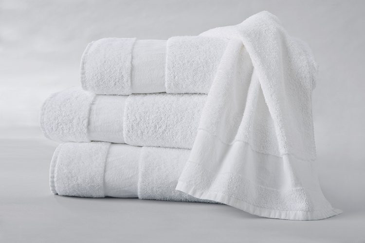 A EuroSoft hand towel draped over a stack of three folded EuroSoft bath towels.
