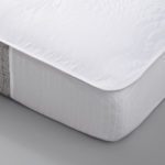 A detail shot of a corner of a mattress featuring a EuroTech Mattress Pad.