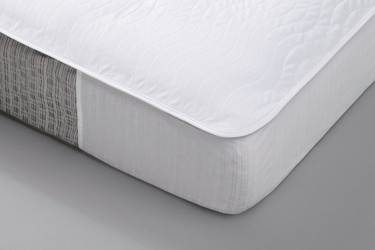 A detail shot of a corner of a mattress featuring a EuroTech Mattress Pad.